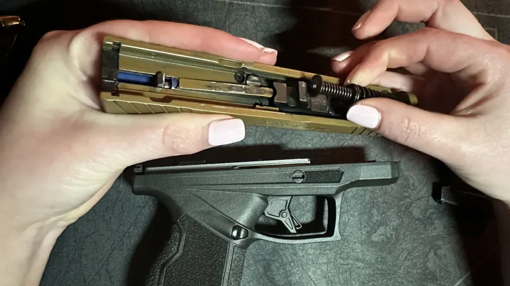 After adding slight pressure and pressing down, the spring could easily be lifted out of the slide.