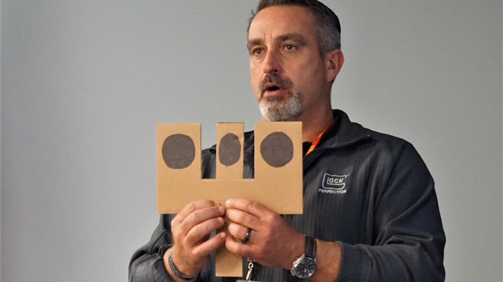 Willie Parent demonstrated to the class how to properly align pistol sights.