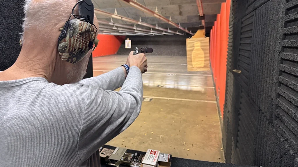 The author Rapid-fire shooting the Walther PPK/s SD with the faux-suppressor attached.