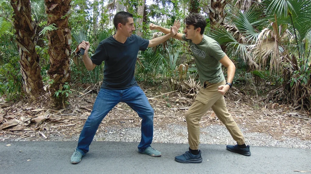 Like a simple stick, there is no “official” location on the belt to grip it for self-defense.