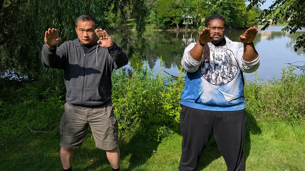 Sam and Kysean demonstrate a basic passive defensive position, relaxed natural stance, hand up, and open.