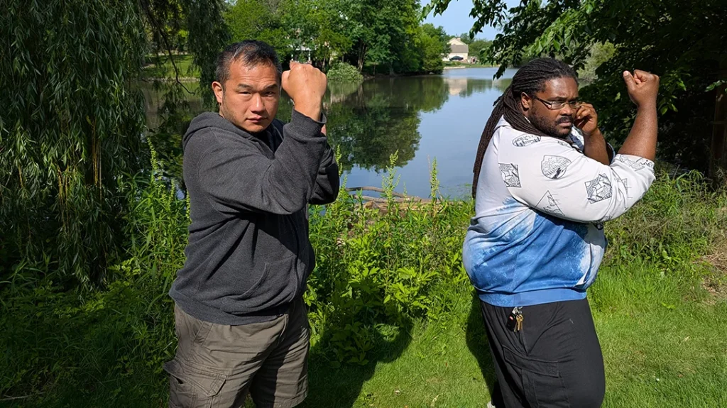 Both step forward into an Inside Middle Block, driving from the outside of their shoulder inward, blocking with their forearms, with the support hand raised into a guard position. Rotate and hand inward, twisting the forearm outward to drive an attacking limb away. Do not just raise your arm to absorb a strike like a punching bag. – Blocking a Punch Part 2
