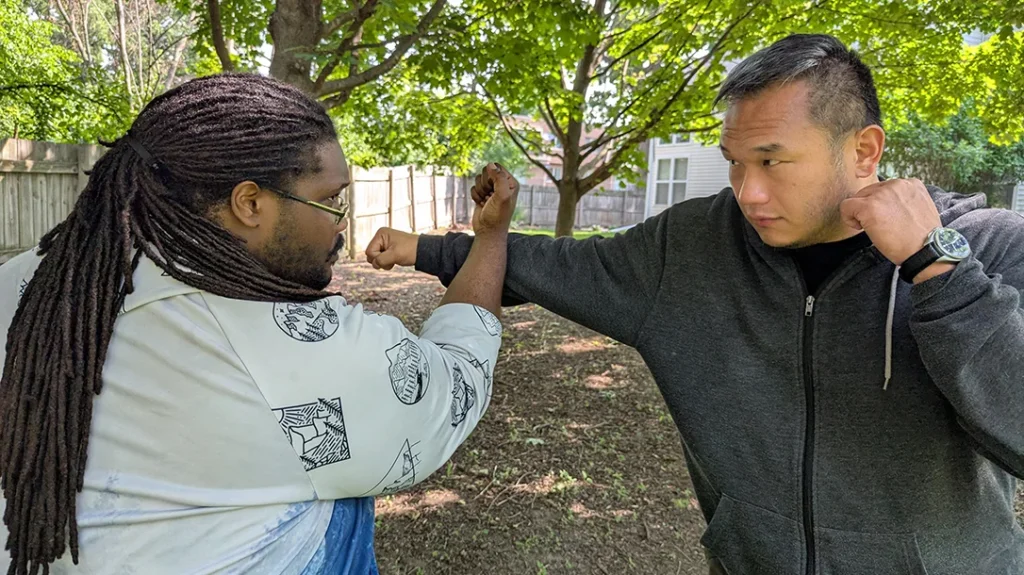 Kysean demonstrates an inside middle block to the inside of Sam’s strike. Notice: Kysean's elbow is low crossing and protecting his mid-section while his fist is at his face level. – Blocking a Punch Part 2