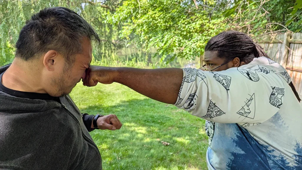 Kysean delivers a counter strike—a left straight punch to Sam’s face. – Blocking a Punch Part 2