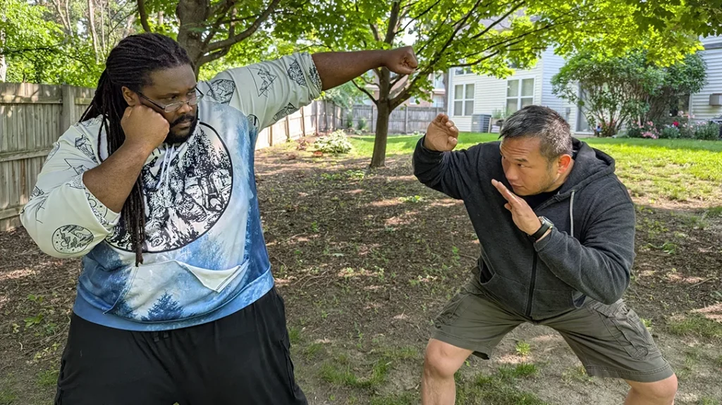 Sam begins to duck under an attempted punch by Kysean.