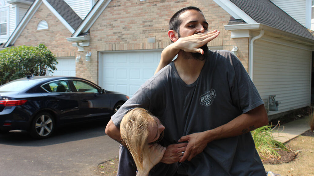 The girl puts her knife-edge hand under the attacker’s nose.