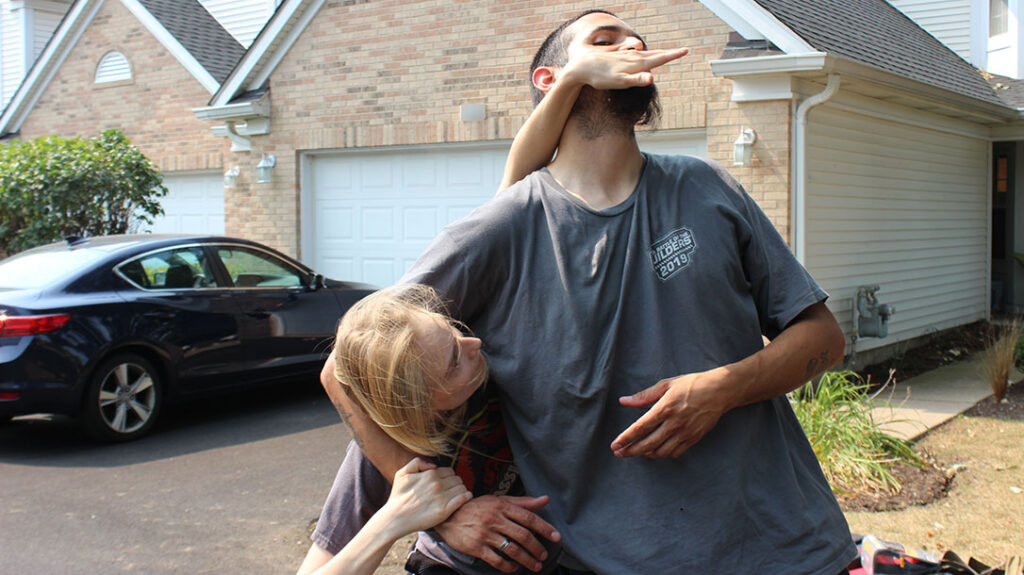 Combatives: Applying pressure, the girl pushes the attacker’s head up and away.