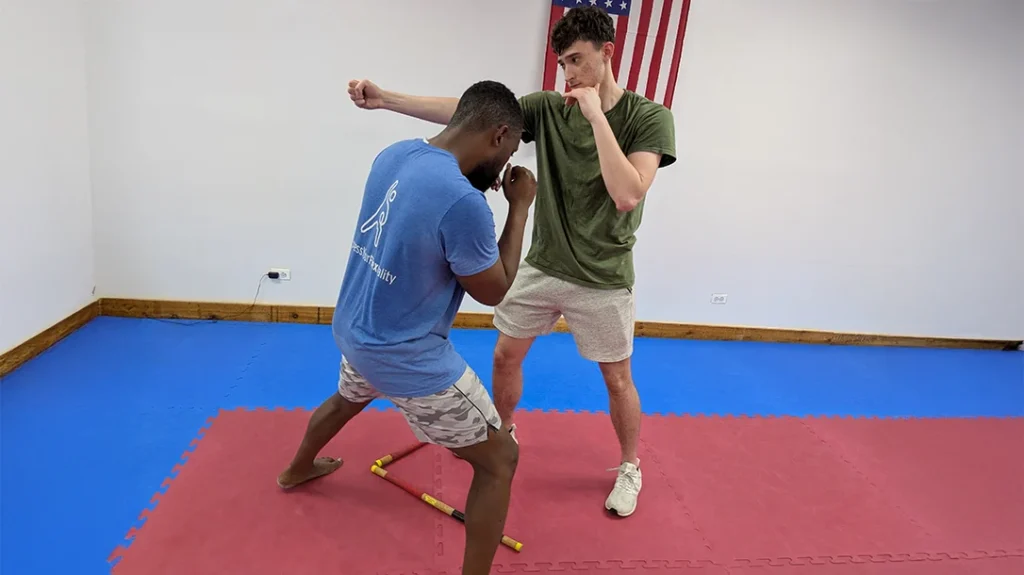 Defensive Footwork: In this Picture, Ben is throwing an ANGLE 1 punch and Brian is stepping off to an ANGLE 1 V-STEP, prepared to counter.