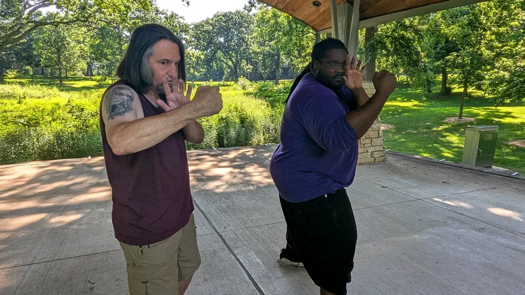 Don and Kysean begin in a fighting stance, elbows are bent, and knuckles are pointed, ready to spring out to their target.