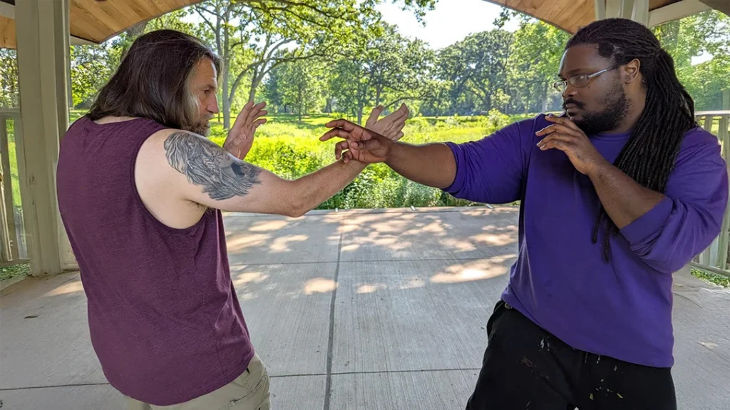 Kysean crosses arms with Don, measuring up his striking range.