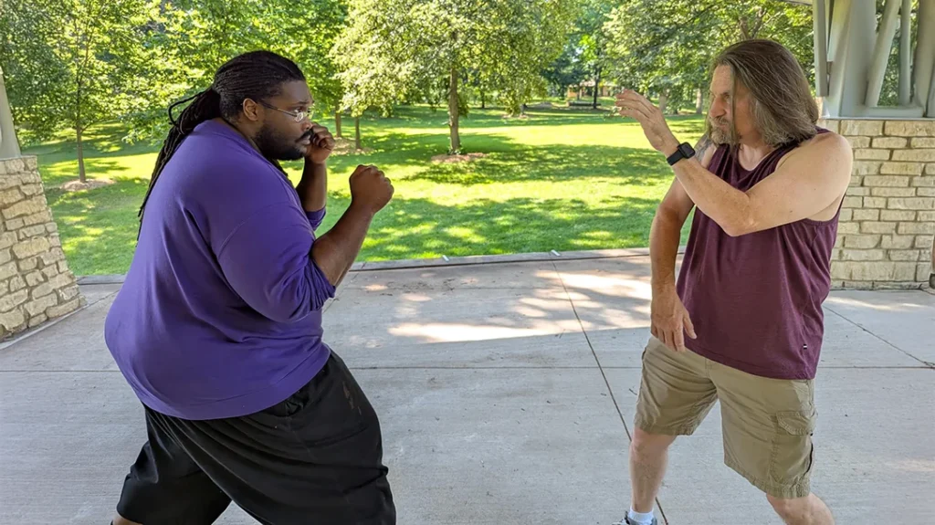 Kysean feeds Don a straight punch.