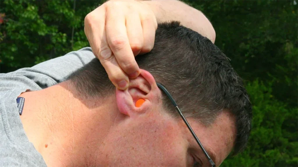 Picking Ear Protection: Tug the top of your ear upwards and insert the hearing protection into the ear canal.