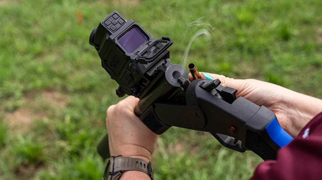 The button on the right side of the Rossi Brawler .300 Blackout, next to the hammer, will open the action when depressed.