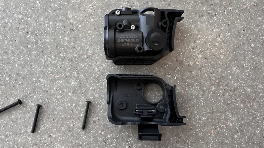 After the firearm was clear and ammunition-free, the author quickly got to work disassembling the Streamlight TLR-6 Weapon Light into two halves.